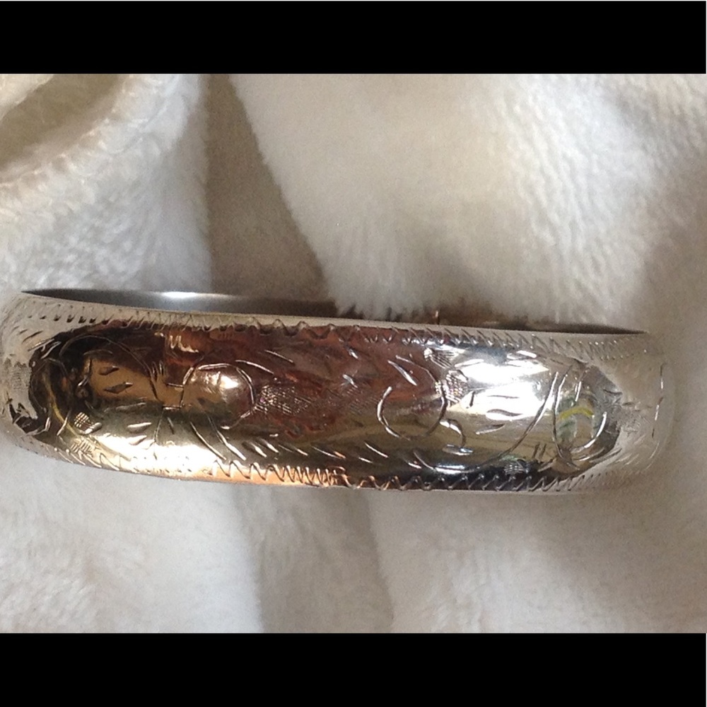 A silver etched bracelet bangle.